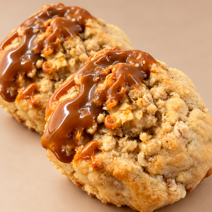 Two golden-brown baked apple crumble cookies topped with a salted caramel drizzle, postage nationwide UK.
